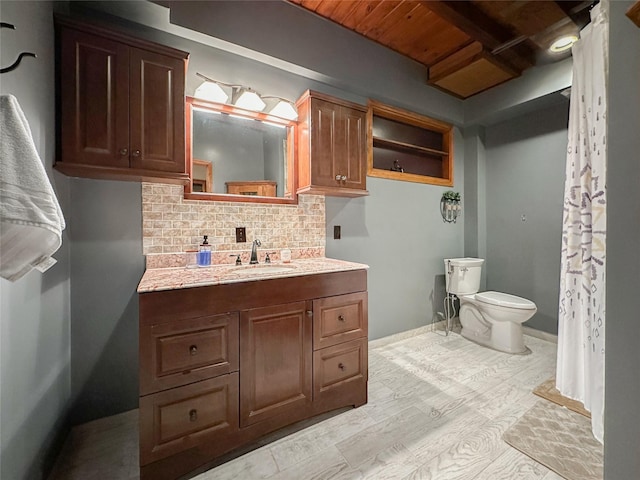 bathroom featuring tasteful backsplash, vanity, wood-type flooring, and toilet