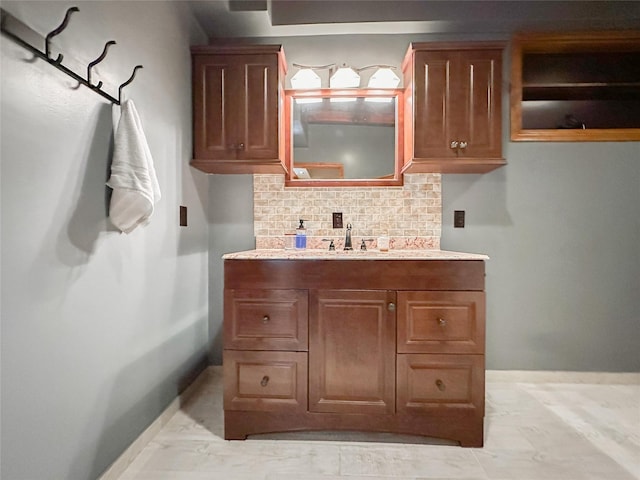 bathroom with vanity and tasteful backsplash