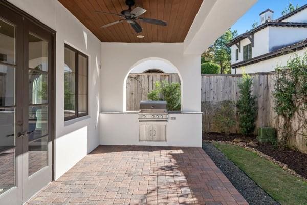 view of patio / terrace featuring ceiling fan, a grill, area for grilling, and french doors