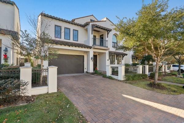 mediterranean / spanish house featuring a balcony and a garage