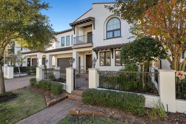 mediterranean / spanish-style home featuring a balcony and a garage