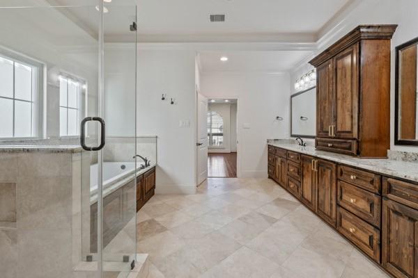 bathroom with shower with separate bathtub, vanity, and ornamental molding