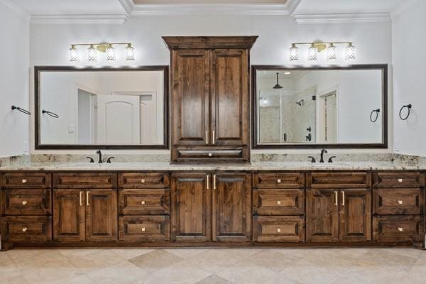 bathroom with vanity, crown molding, and walk in shower