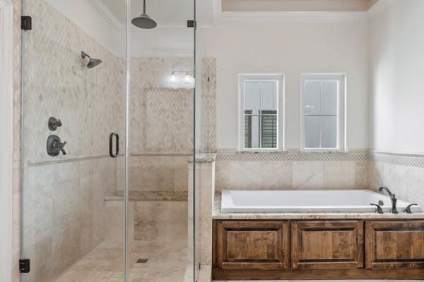 bathroom featuring crown molding and shower with separate bathtub