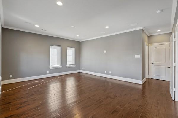 unfurnished room featuring dark hardwood / wood-style flooring and crown molding