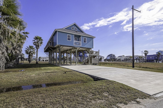 view of front of house with a front lawn and a carport