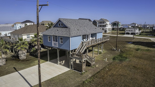 rear view of house featuring a carport and a yard