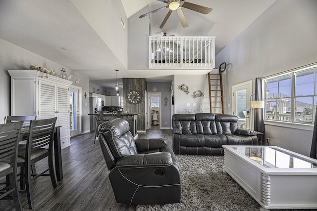 living room featuring dark hardwood / wood-style floors, vaulted ceiling, and ceiling fan