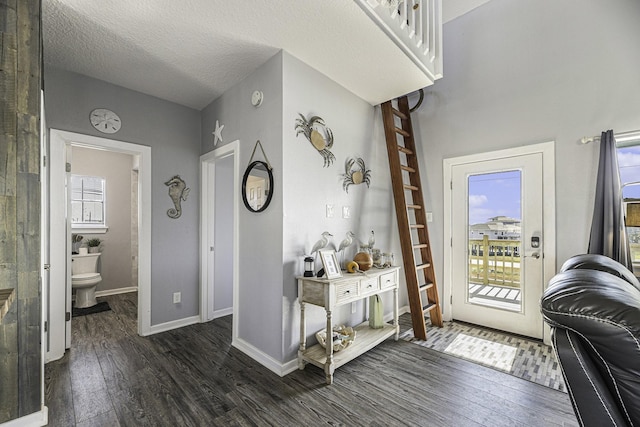 entryway featuring dark wood-type flooring and a textured ceiling