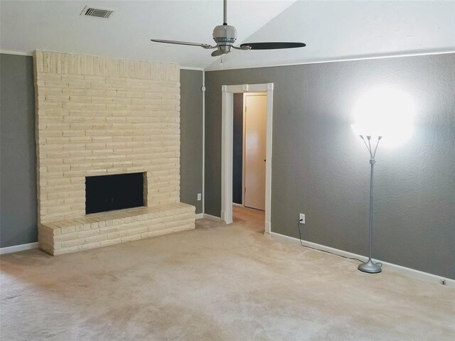 unfurnished living room with carpet, ceiling fan, ornamental molding, and a fireplace