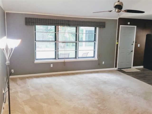 unfurnished room with light carpet, ceiling fan, and ornamental molding