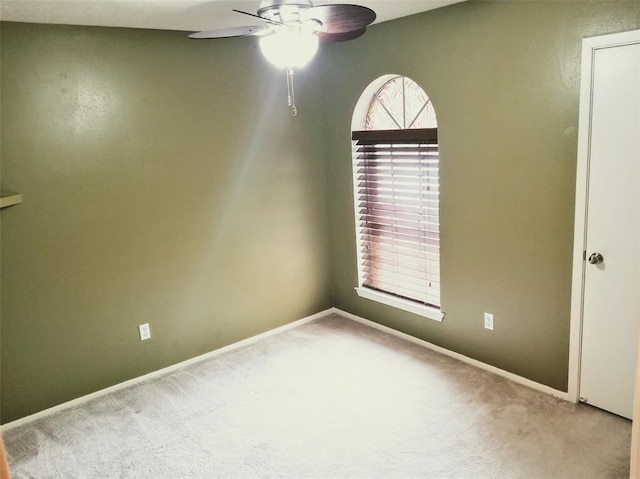 carpeted empty room with ceiling fan