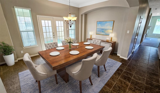 dining space with french doors and a notable chandelier