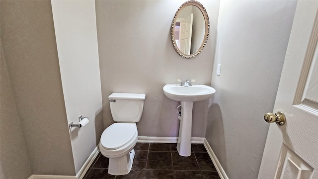 bathroom with tile patterned flooring, toilet, and sink