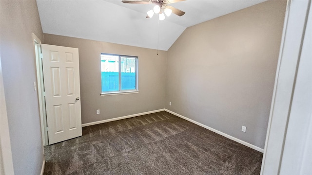 carpeted spare room with ceiling fan and lofted ceiling