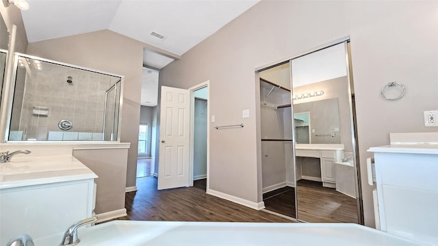 bathroom with vanity, lofted ceiling, and hardwood / wood-style flooring