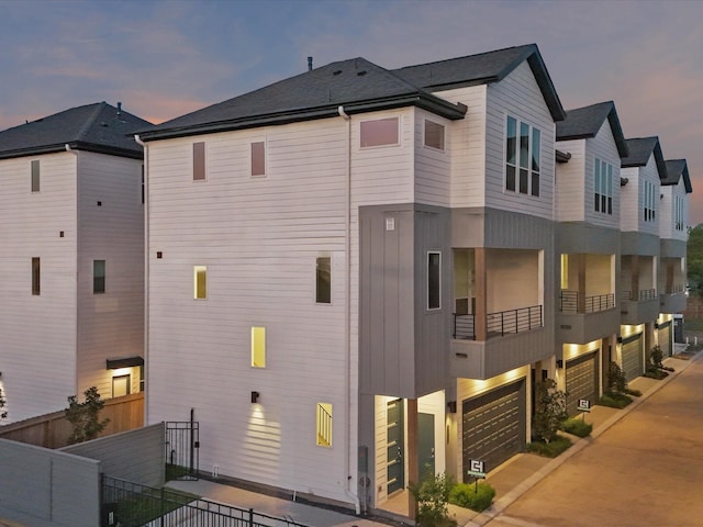 property exterior at dusk featuring a garage