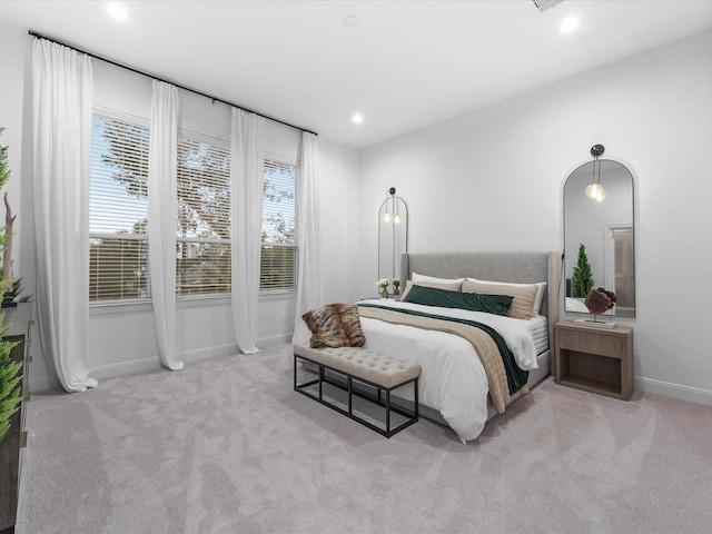 bedroom featuring light carpet and multiple windows