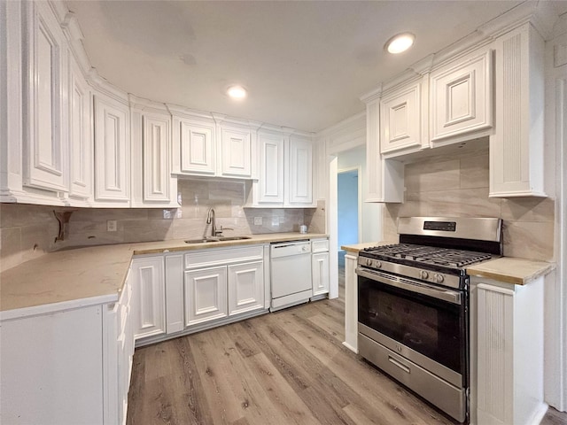 kitchen featuring white cabinets, stainless steel gas range, sink, light hardwood / wood-style flooring, and dishwasher