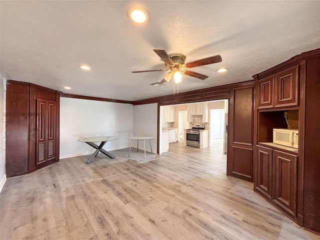 interior space featuring a textured ceiling, light wood-type flooring, ceiling fan, and ornamental molding