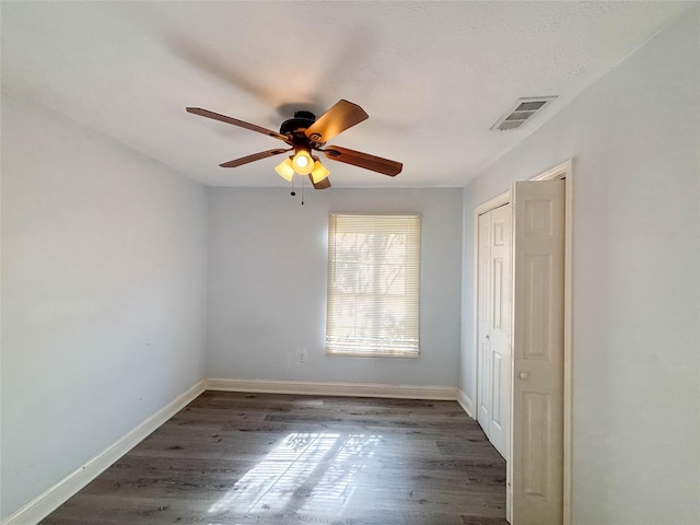 spare room featuring ceiling fan and dark hardwood / wood-style flooring