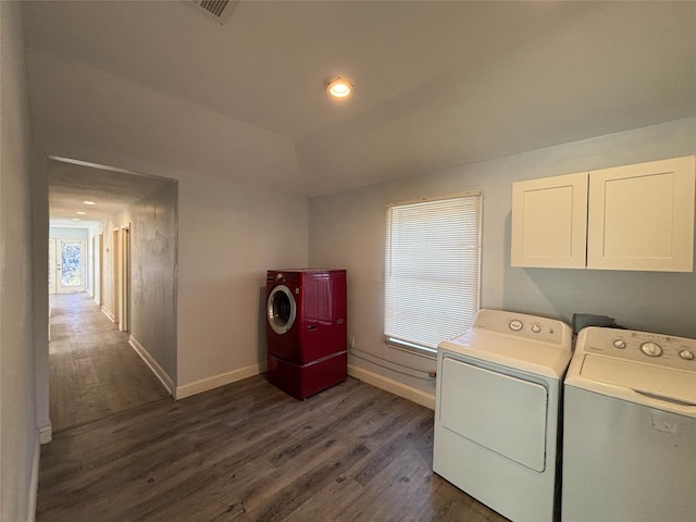 laundry area with dark wood-type flooring, cabinets, and independent washer and dryer