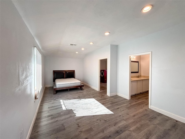 unfurnished bedroom with wood finished floors, baseboards, visible vents, lofted ceiling, and recessed lighting