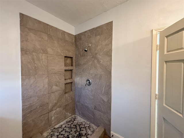 bathroom with a tile shower