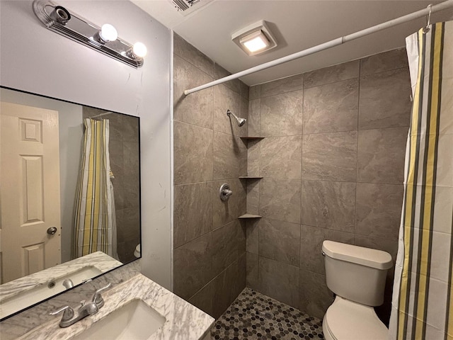 bathroom featuring curtained shower, vanity, and toilet