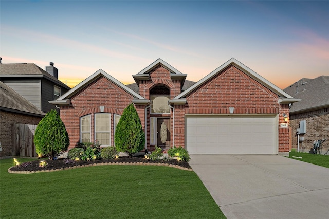 view of property featuring a garage and a lawn