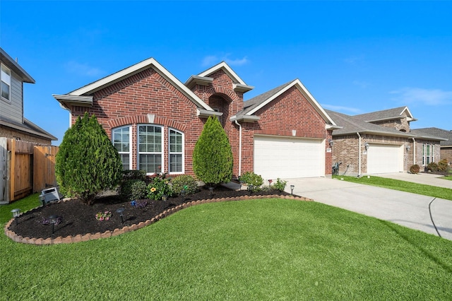 view of property featuring a front yard and a garage