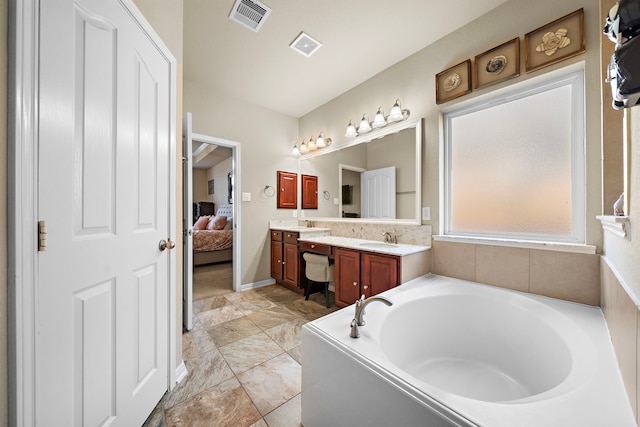 bathroom featuring vanity and a tub to relax in