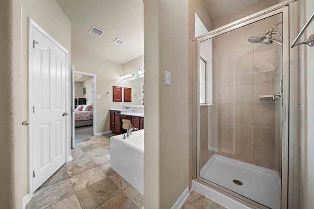 bathroom with vanity and separate shower and tub