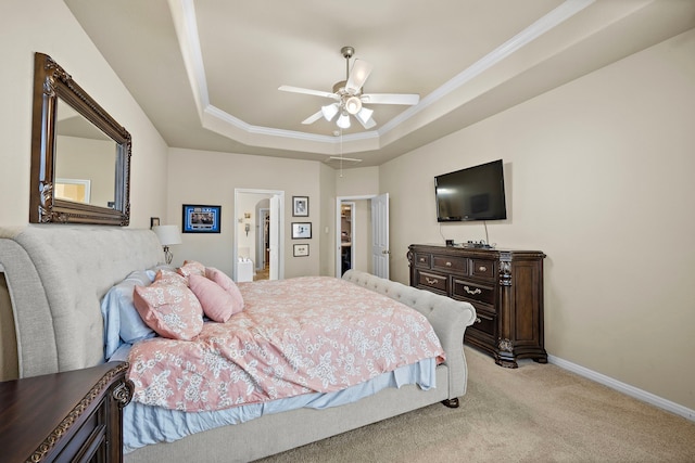 carpeted bedroom with crown molding, ceiling fan, connected bathroom, and a raised ceiling