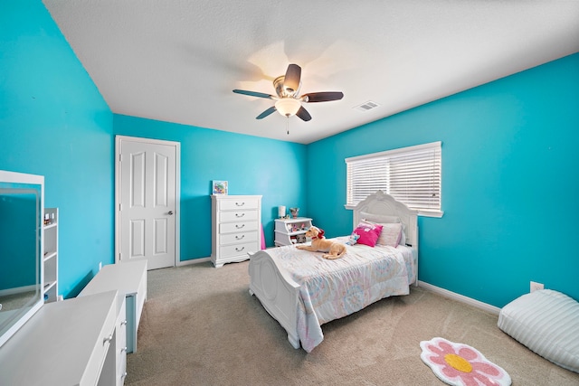 bedroom with ceiling fan and light carpet