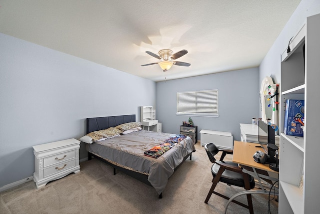 bedroom with ceiling fan, light carpet, and a textured ceiling