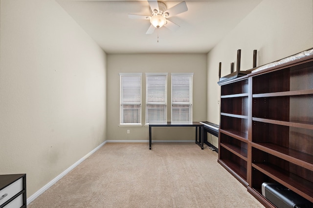 carpeted empty room featuring ceiling fan