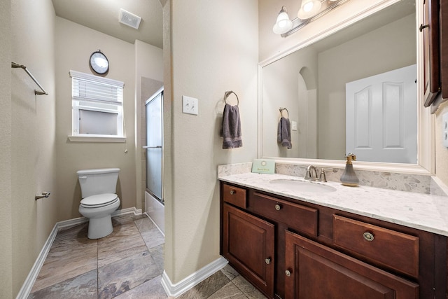 full bathroom featuring vanity, bath / shower combo with glass door, and toilet