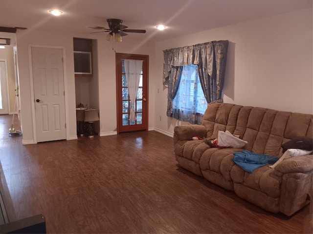 living room with ceiling fan and dark hardwood / wood-style floors