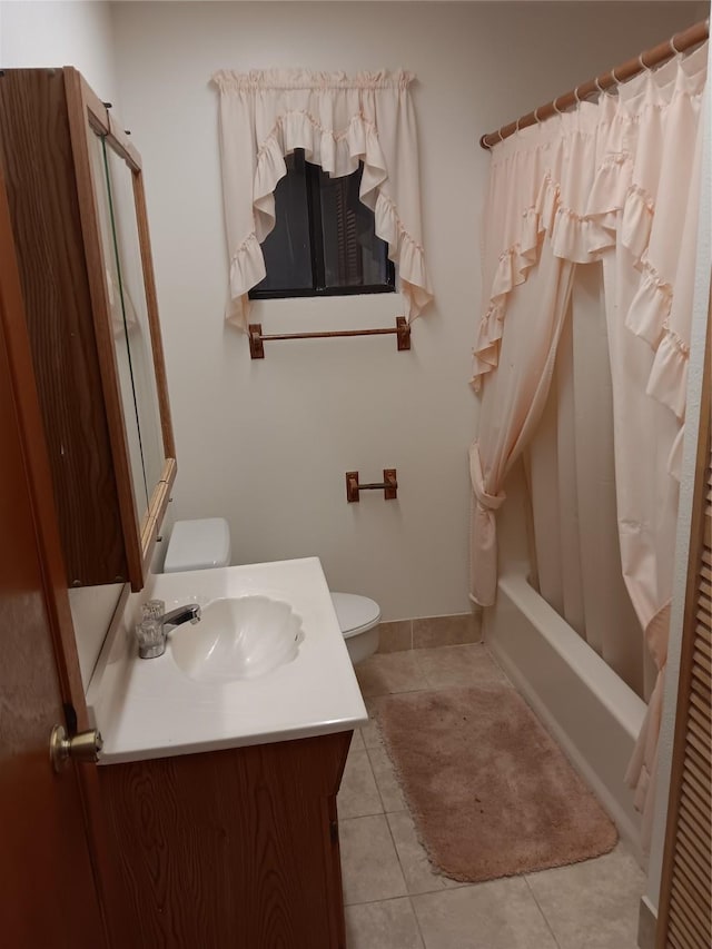 full bathroom with tile patterned flooring, shower / tub combo, vanity, and toilet