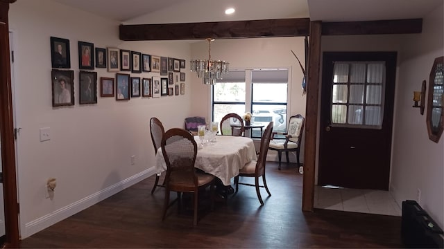 dining space with dark hardwood / wood-style flooring and a chandelier