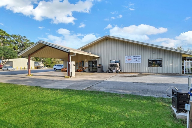 view of vehicle parking featuring a carport and a yard