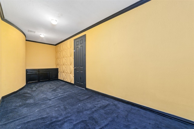 carpeted empty room featuring ornamental molding