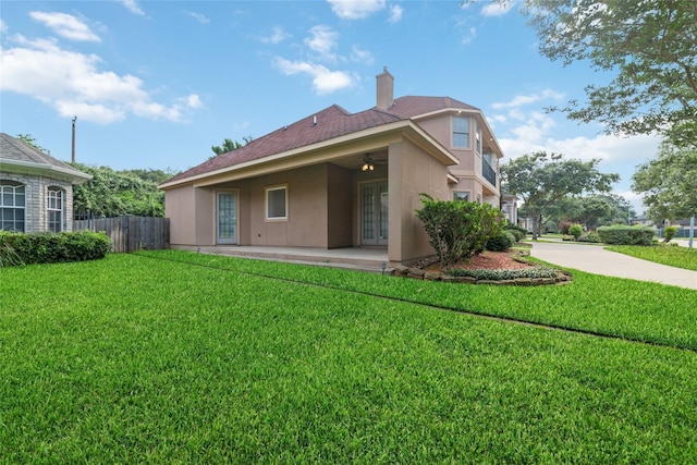 back of house featuring a yard