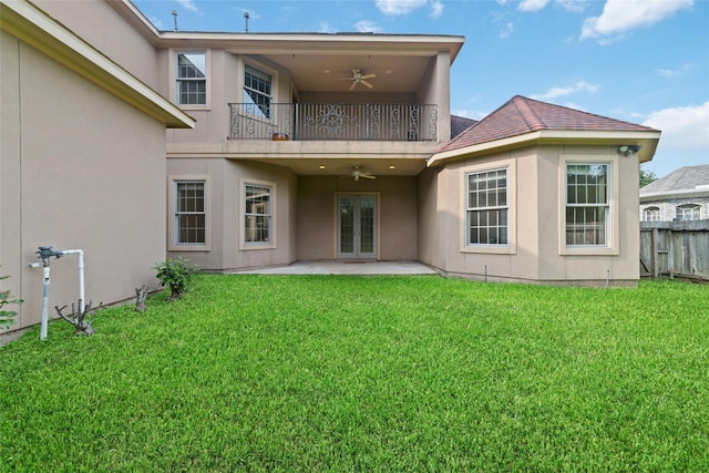 back of house with french doors, a balcony, ceiling fan, a yard, and a patio