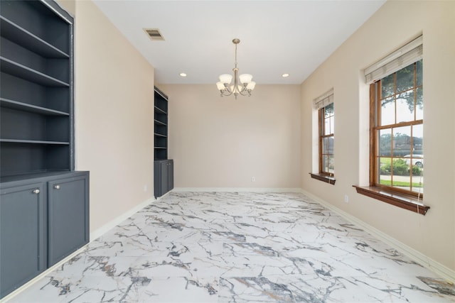 unfurnished dining area with built in features and an inviting chandelier