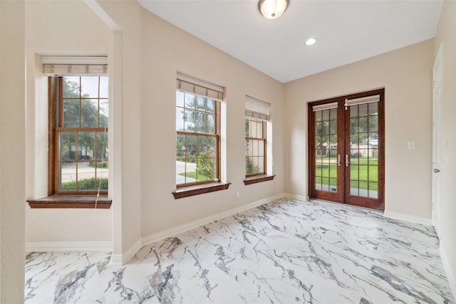 entrance foyer with french doors and a healthy amount of sunlight