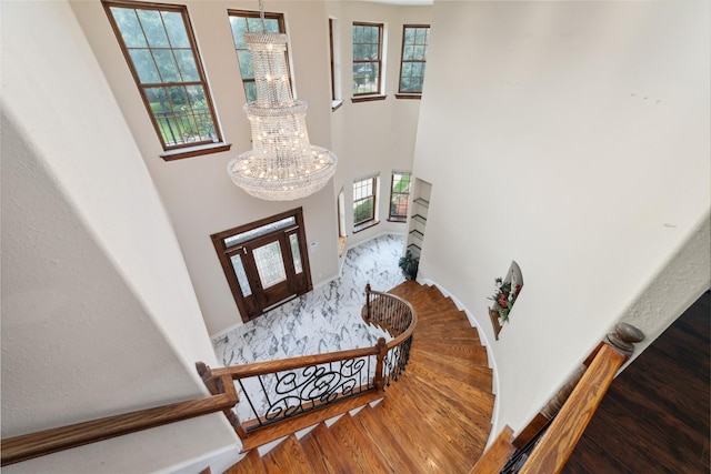 entrance foyer with hardwood / wood-style floors and a notable chandelier