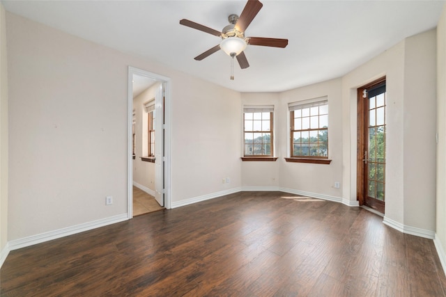 spare room featuring ceiling fan and dark wood-type flooring