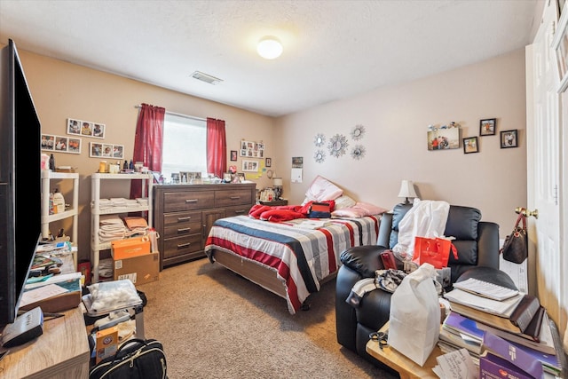 carpeted bedroom featuring a textured ceiling